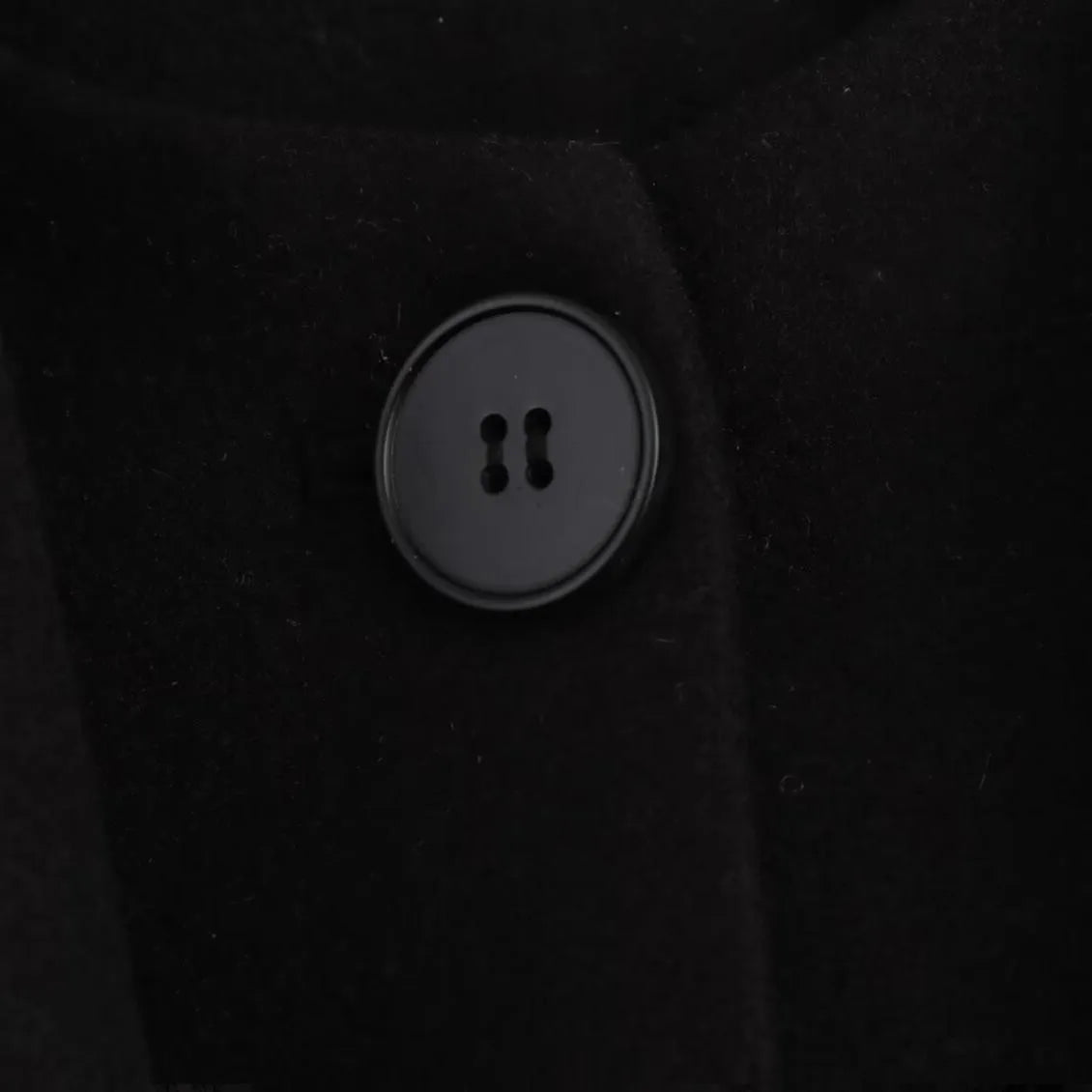 Long grey women's polyester overcoat with a black faux fur collar on a hanger.