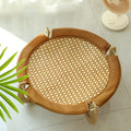 Brown woven rattan elevated hammock bed for cats and small dogs on a wooden floor.