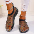 Women's flat sandals with mesh upper, colourful rhinestone design, and round toe on a rubber sole.
