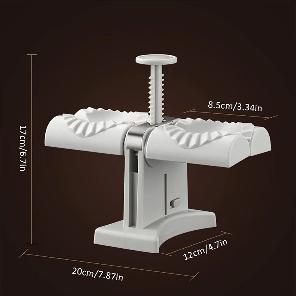 White double-head manual dumpling mould with stainless steel and plastic construction on a rubber anti-slip mat.