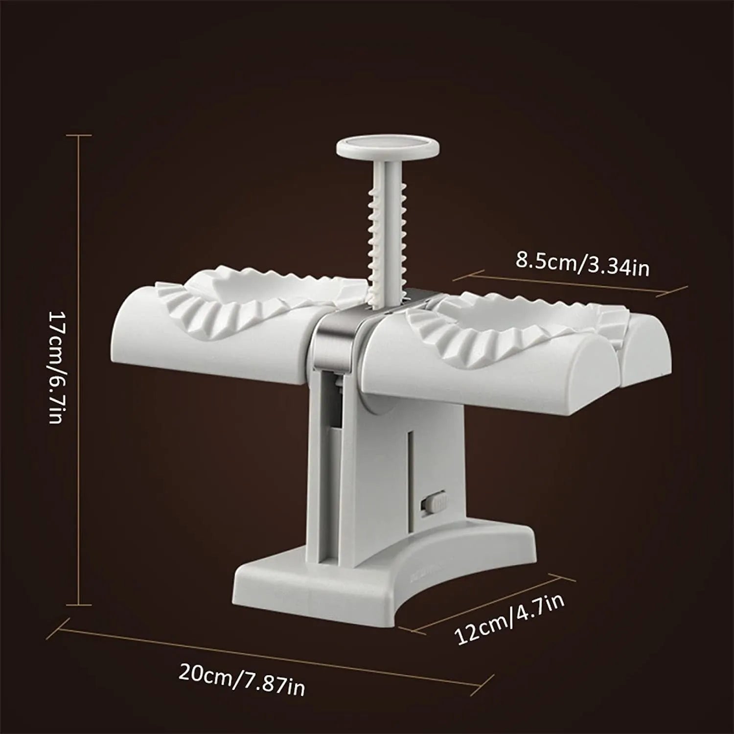White double-head manual dumpling mould with stainless steel and plastic construction on a rubber anti-slip mat.