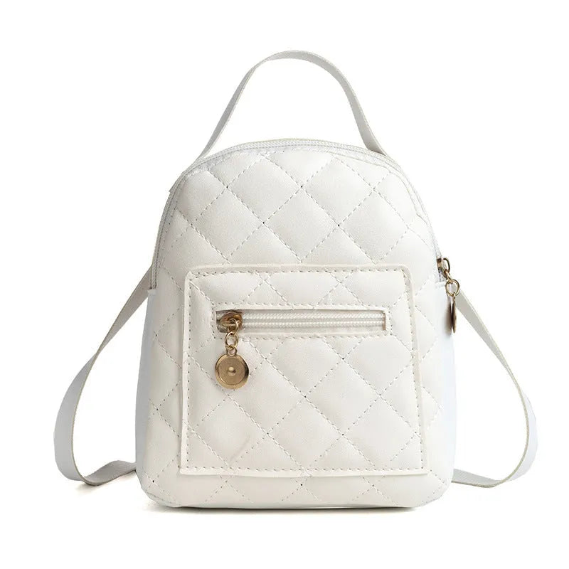 Small white embroidered hardback girls' backpack in a vertical square shape on a plain background.