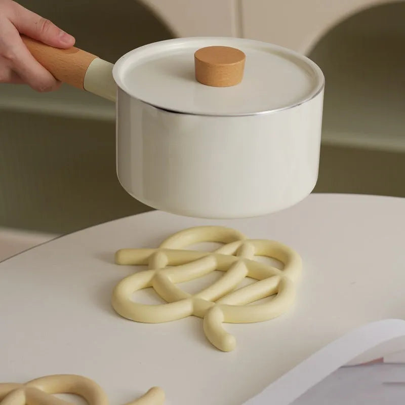Ceramic heat-proof mat in an irregular shape on a kitchen table