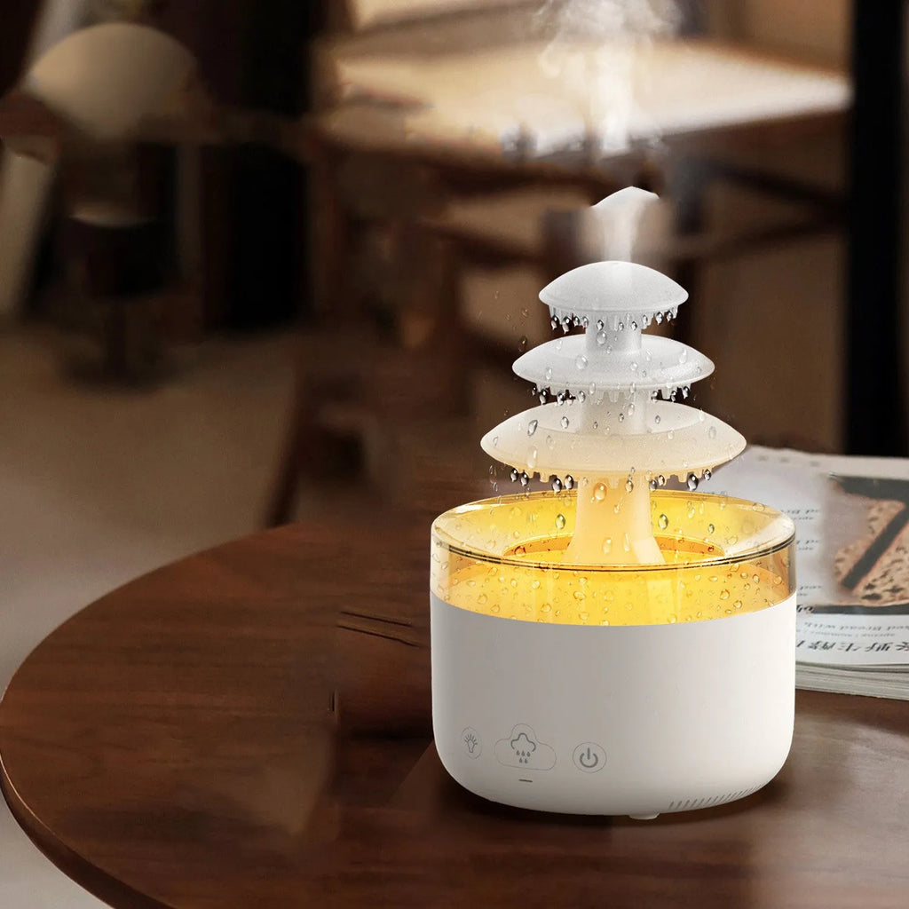 White cloud-shaped ultrasonic humidifier and essential oil diffuser with colourful LED light on base.