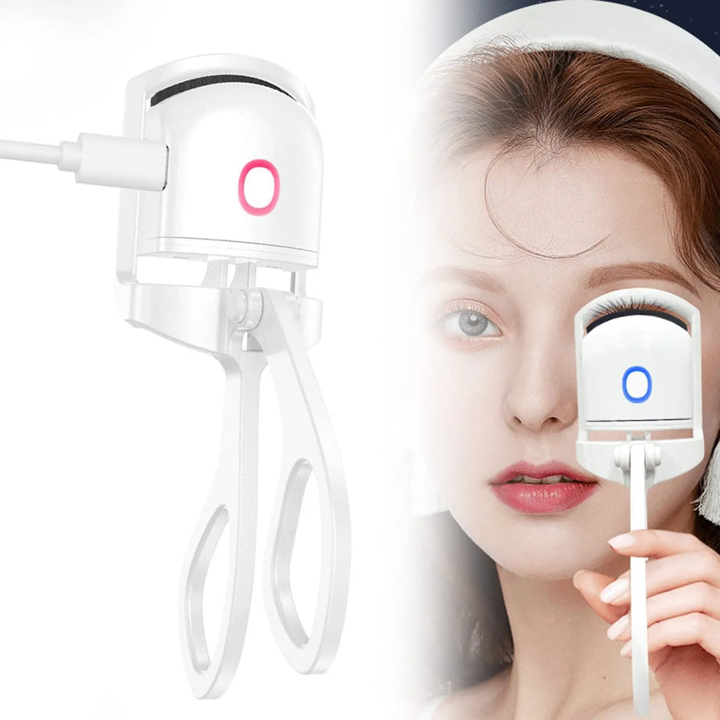 White USB rechargeable heated eyelash curler with dual temperature lights, shown next to its charging cable.