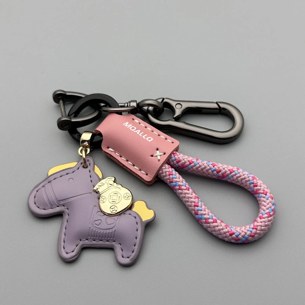 Handmade cowhide car key ring pendant with zinc alloy pony belt buckle charm and flanelle rope in various colours.