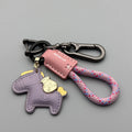 Handmade cowhide car key ring pendant with zinc alloy pony belt buckle charm and flanelle rope in various colours.