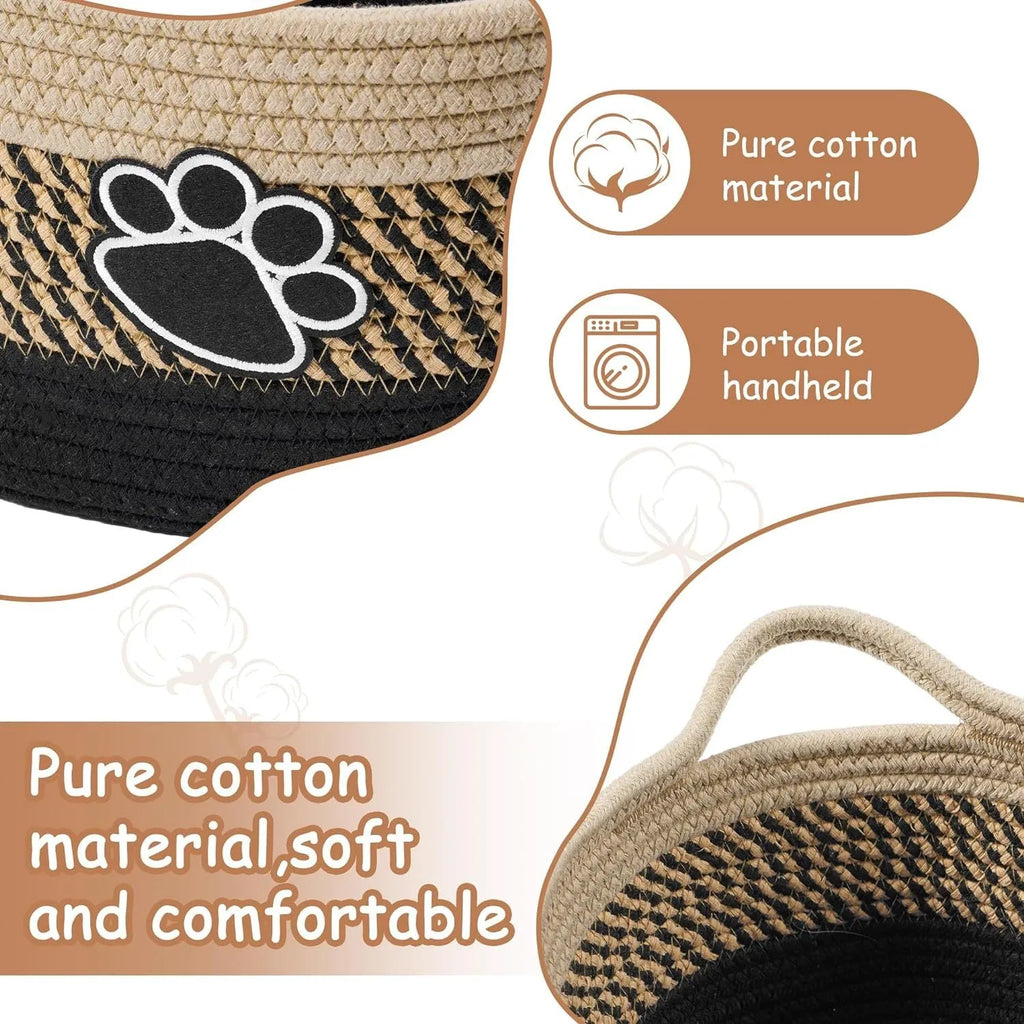 Small light beige woven cotton rope storage basket with a handle on a wooden surface