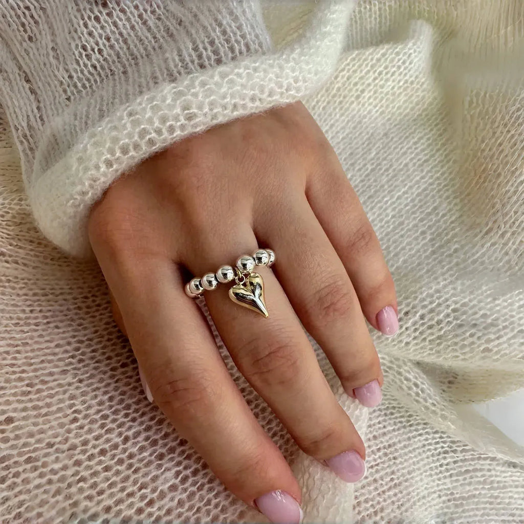 Handmade beaded elastic string love ring with geometric heart design in gold or white colours