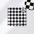 Ins style A5 grid notebook open on a desk, showing grid paper and one of twelve colourful cover designs like pineapple or checkerboard.