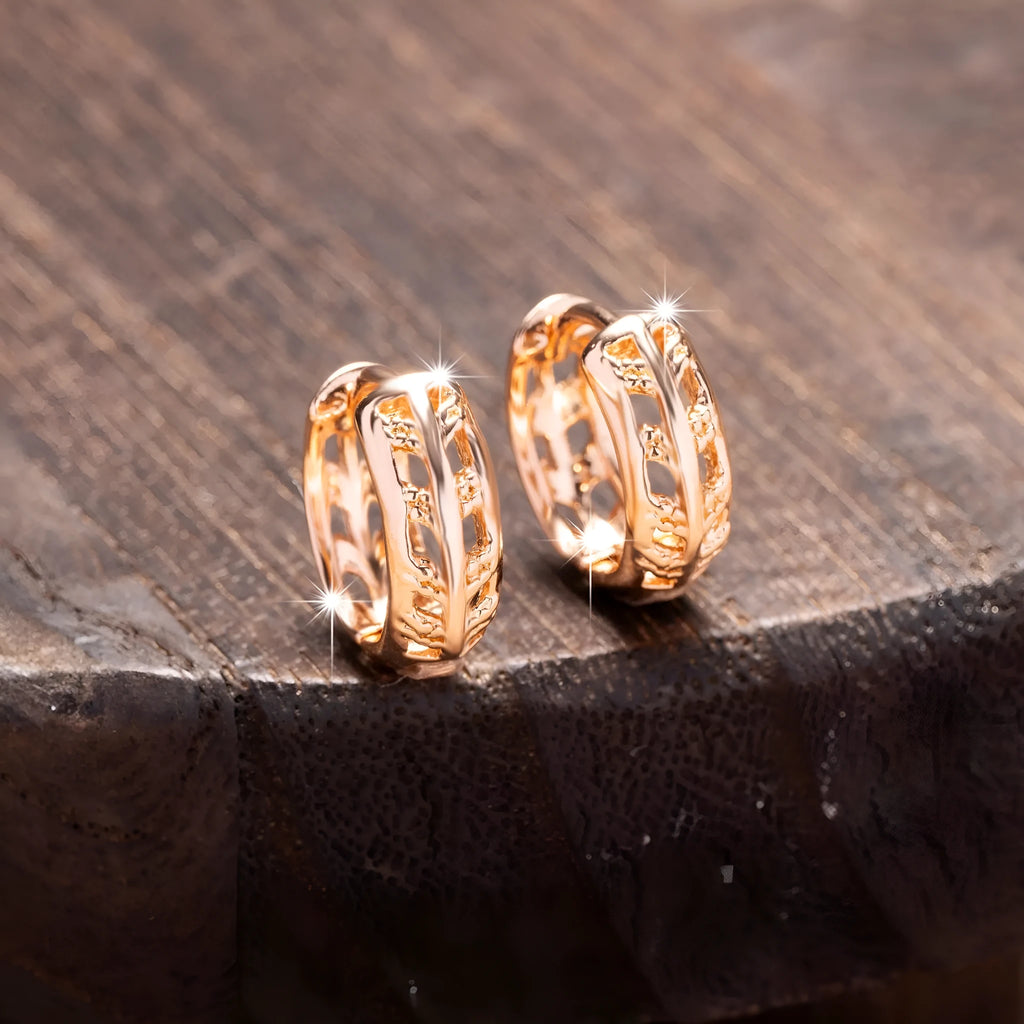 Rose gold plated copper stud earrings with hollowed leaf and heart design.