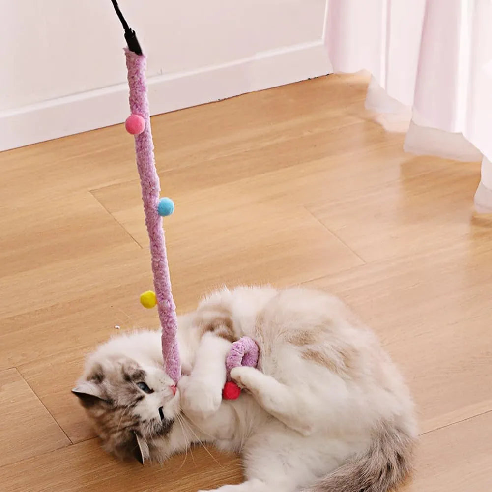 Blue cat wand toy with long plush strip and colourful feather balls attached, held upright.