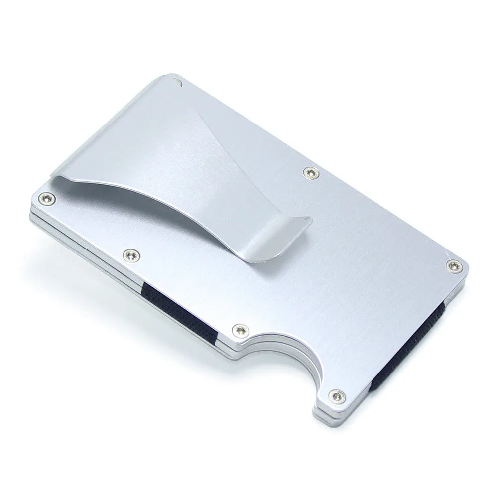 Geometric carbon fibre and aluminium business card holder, 8mm thick, on a table.