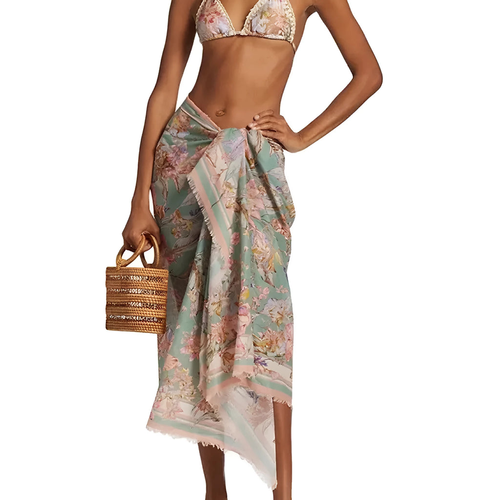 Women's creamy-white floral bikini set with separate skirt on beach