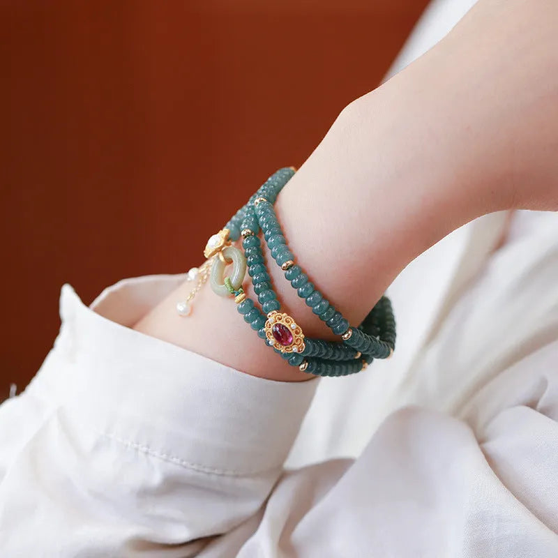 Blue water jade abacus bead bracelet with three silver rings and tourmaline pearls