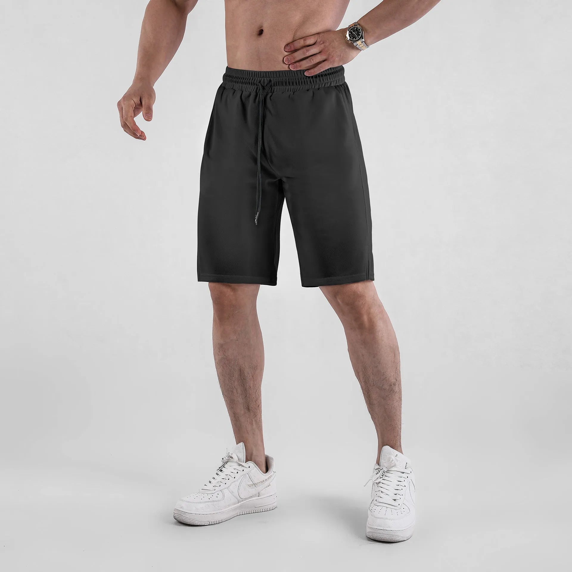 Men's black quick-drying mesh sports shorts with a loose fit and elasticated waist.