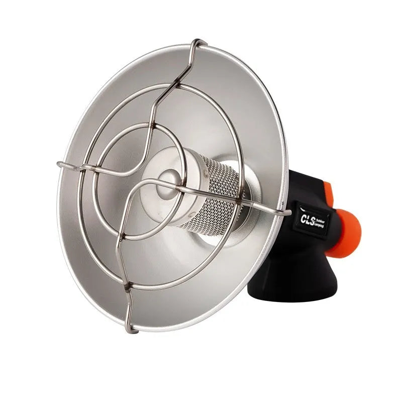 Black and orange portable outdoor heating stove with automatic ignition on a table.