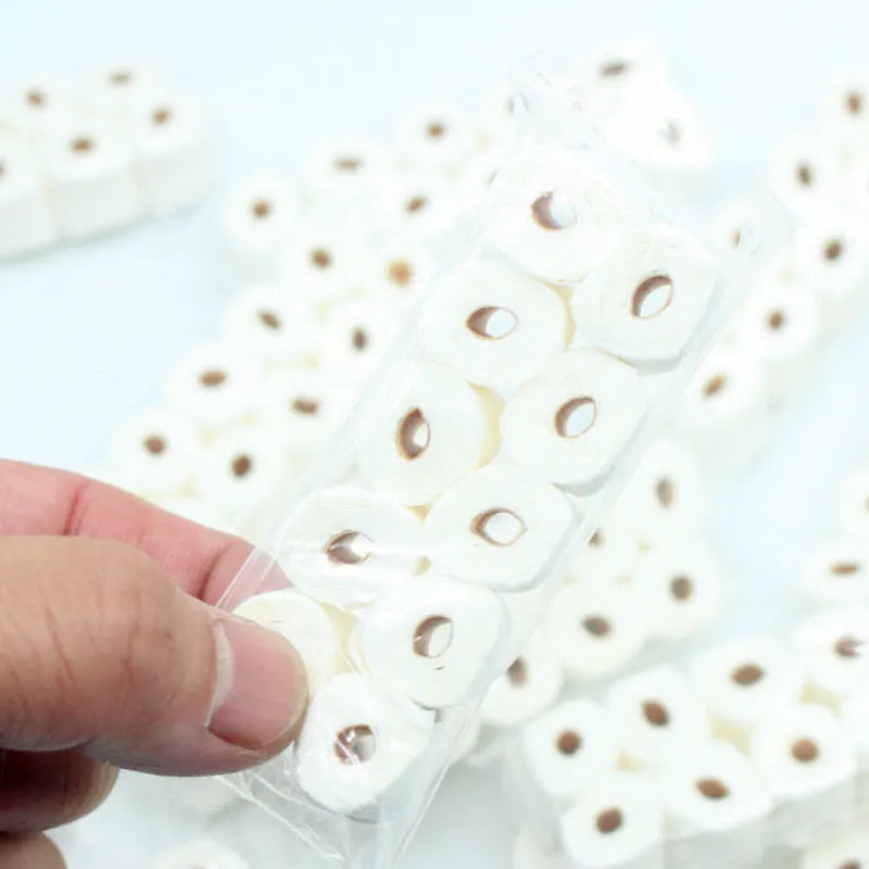 Miniature simulated toilet paper roll toy model for dollhouses, made of paper.