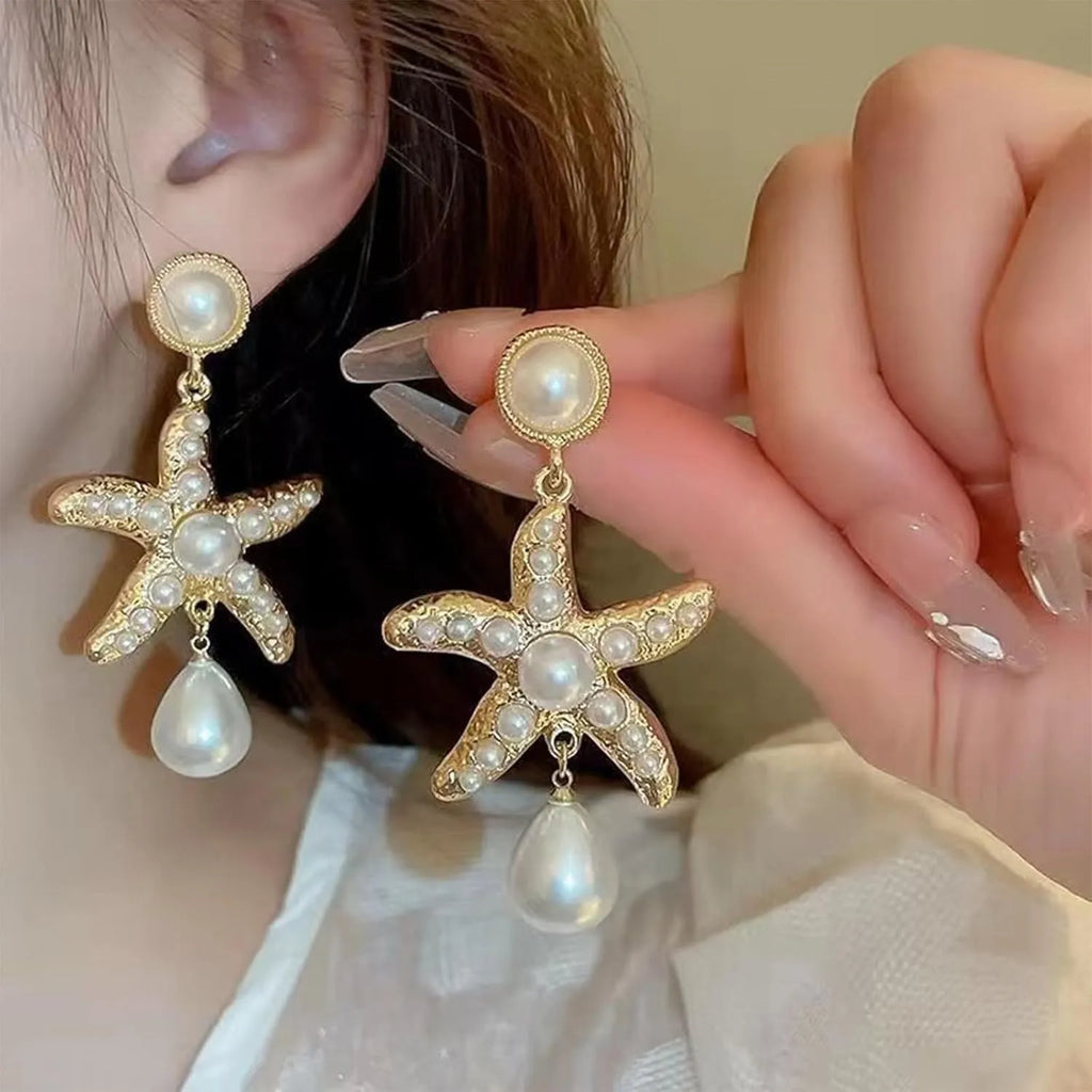 Women's silver-tone pearl starfish earrings on light background