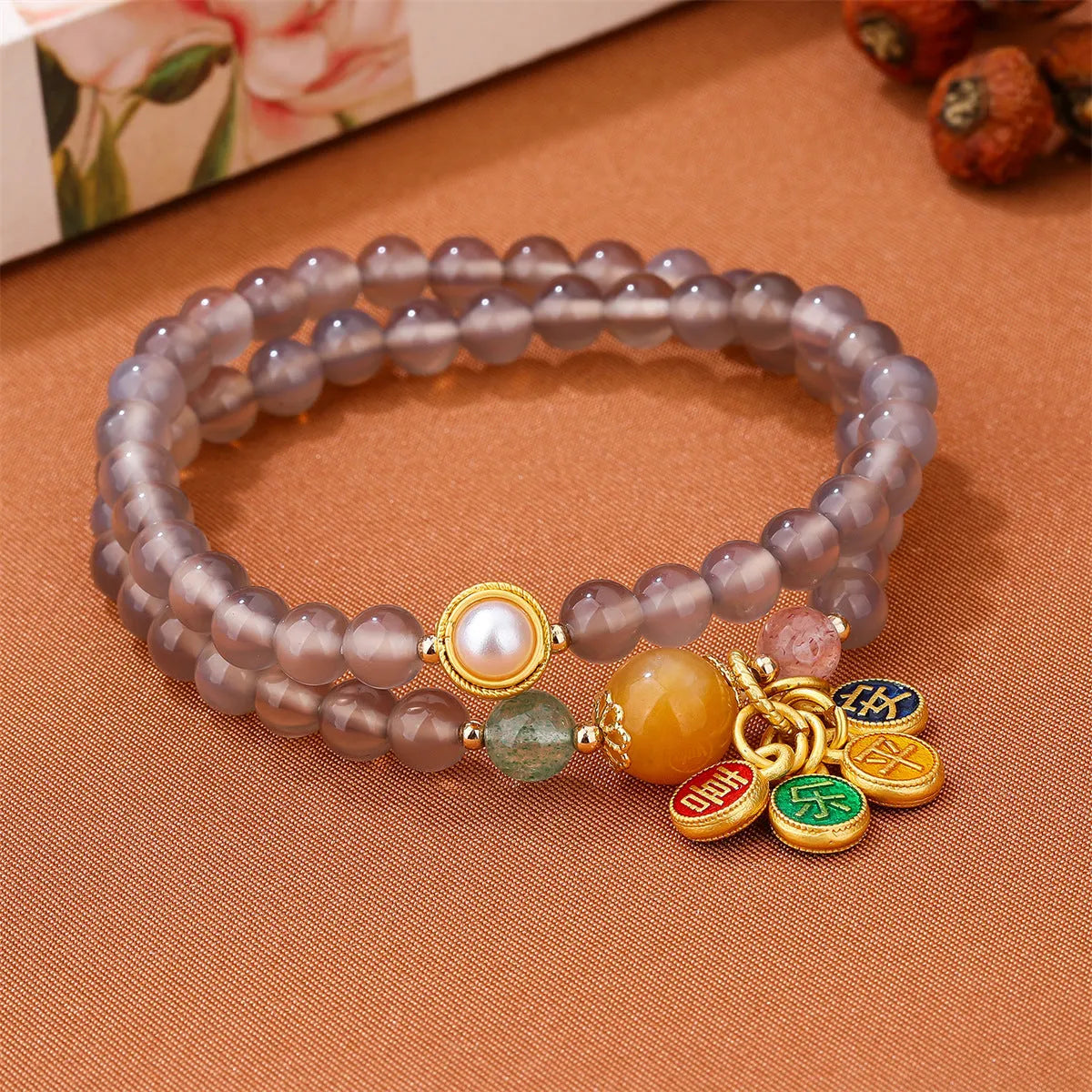 Natural gray agate two-circle bracelet on an adjustable cord, showing hand-polished stone detail.