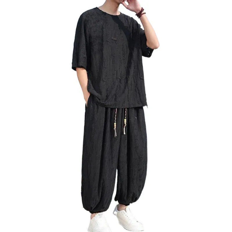 Men's lightweight knitted two-piece suit with short sleeves and cropped trousers in grey.