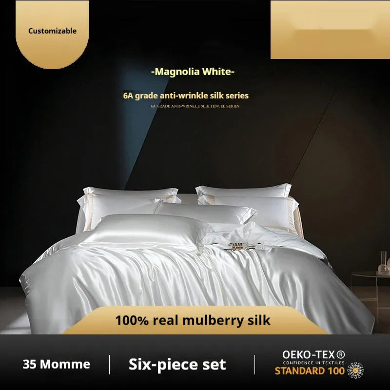 Solid colour silk quilt cover set with pillowcases on a bed, shown in a light luxury style.