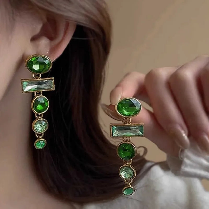 A pair of geometric green gradient alloy earrings with a long tassel and inlaid zircon stones.