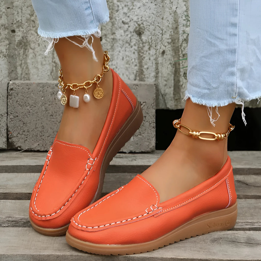 Women's flat loafer in PU leather with round toe and car suture detail, shown in multiple colours.