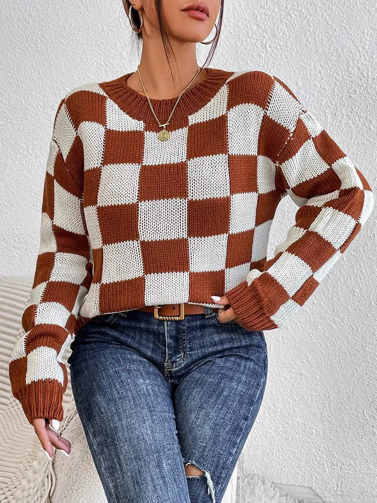 Dark brown loose plaid pullover sweater with a chessboard pattern and long sleeves.