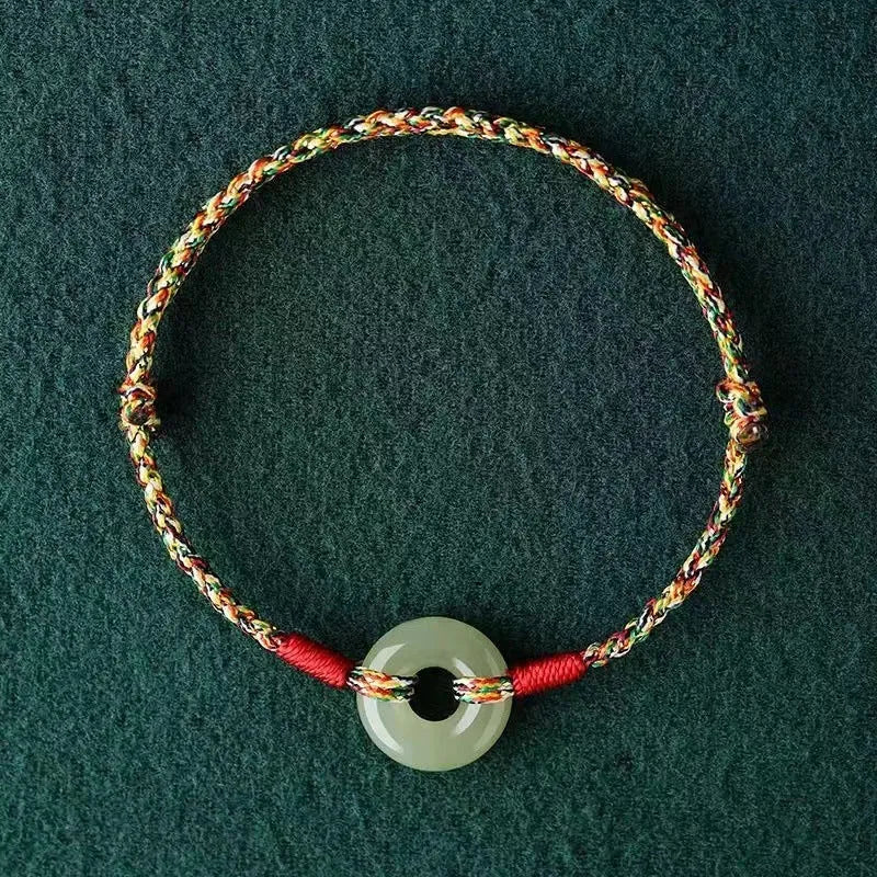 Colourful braided rope bracelet with peace buckle closure on woven design