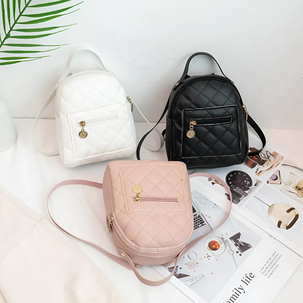 Small white embroidered hardback girls' backpack in a vertical square shape on a plain background.