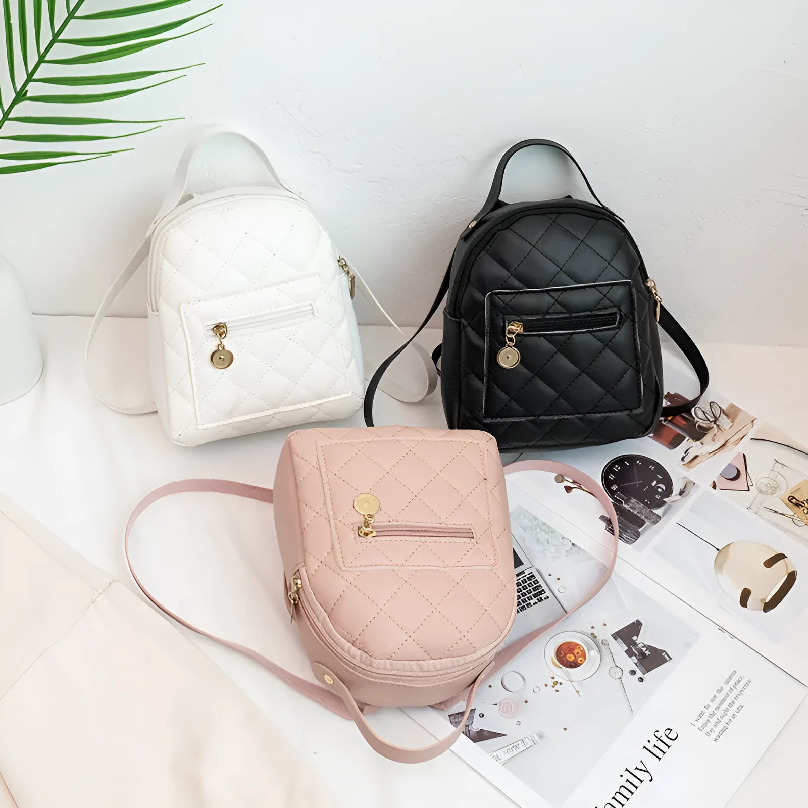 Small white embroidered hardback girls' backpack in a vertical square shape on a plain background.