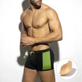 Yellow polka dot print men's swimming boxers on a mannequin, showing brief style.