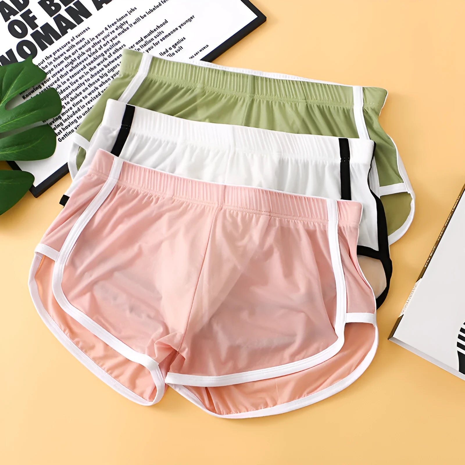 Men's ice silk boxer shorts in multiple colours showing low-waist mesh sports design.