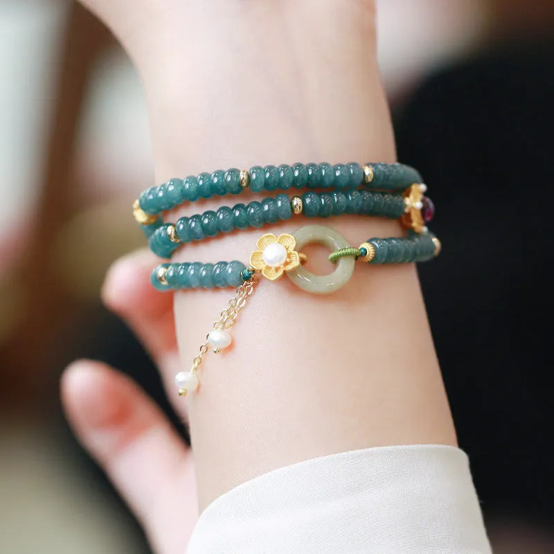 Blue water jade abacus bead bracelet with three silver rings and tourmaline pearls