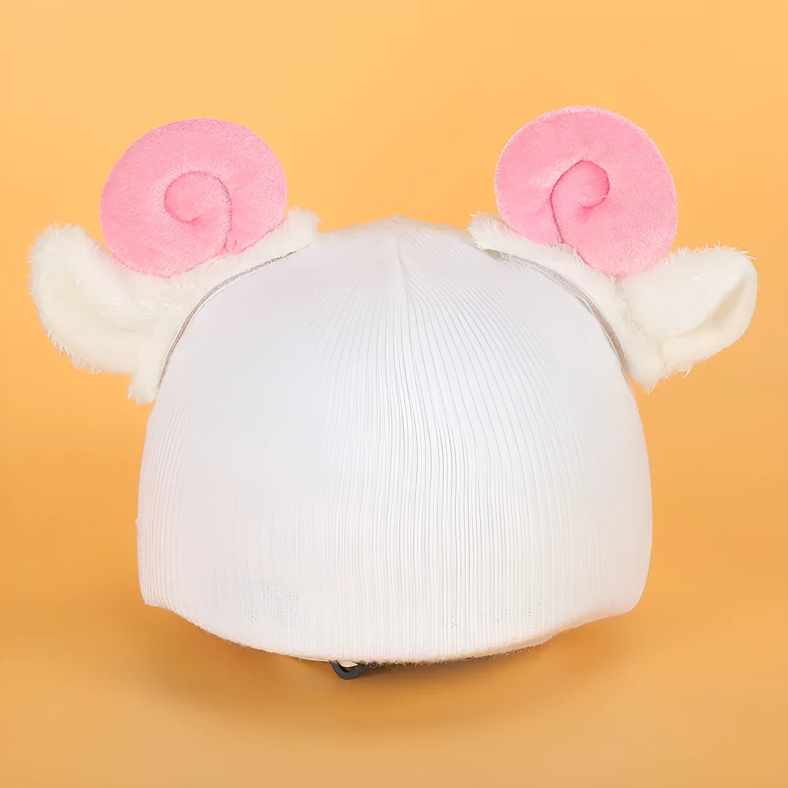 Plush cartoon-themed cover set on a medium motorcycle helmet with soft ear decorations.