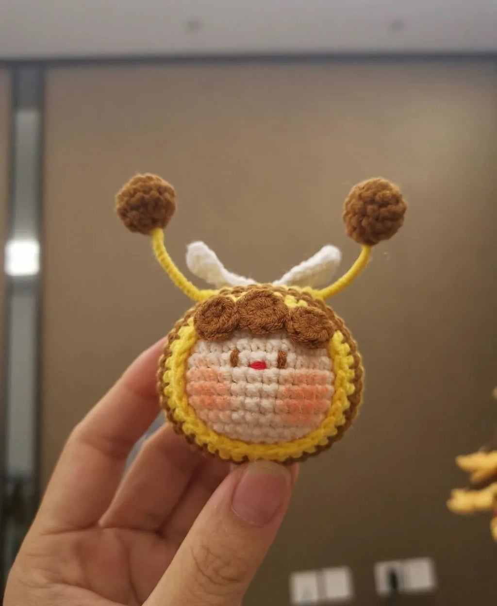 Handmade crocheted bee colony pendant accessory for a woolen doll.