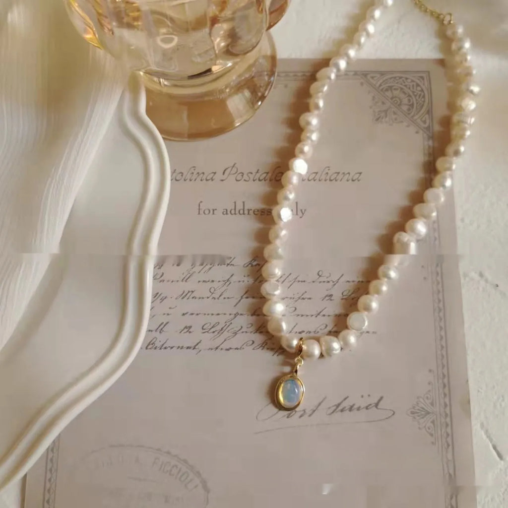 Adjustable geometric alloy pendant necklace with electroplated finish on a grey background.