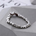 Handmade wooden bracelet with irregular silver square charm on elastic band