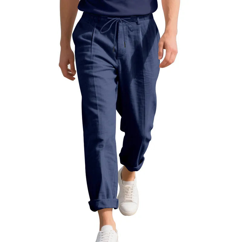 Men's linen casual trousers in a straight-leg style with drawstring waist, shown in a summer colour option.