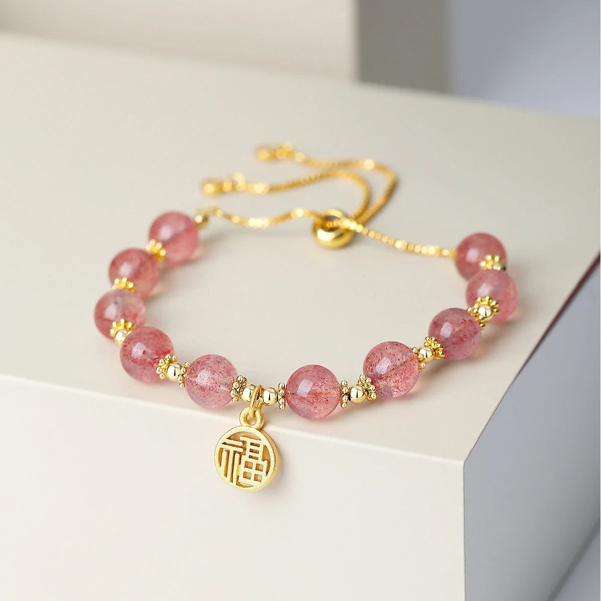 Strawberry quartz crystal bracelet with geometric shapes and fu charm for women