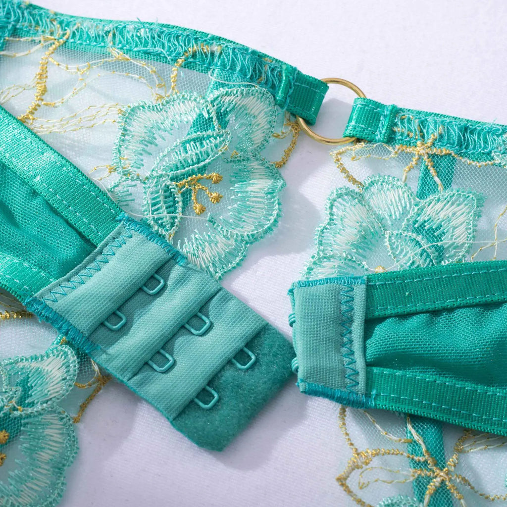 Light green women's embroidered bra set with three-point style and tights on a mannequin.
