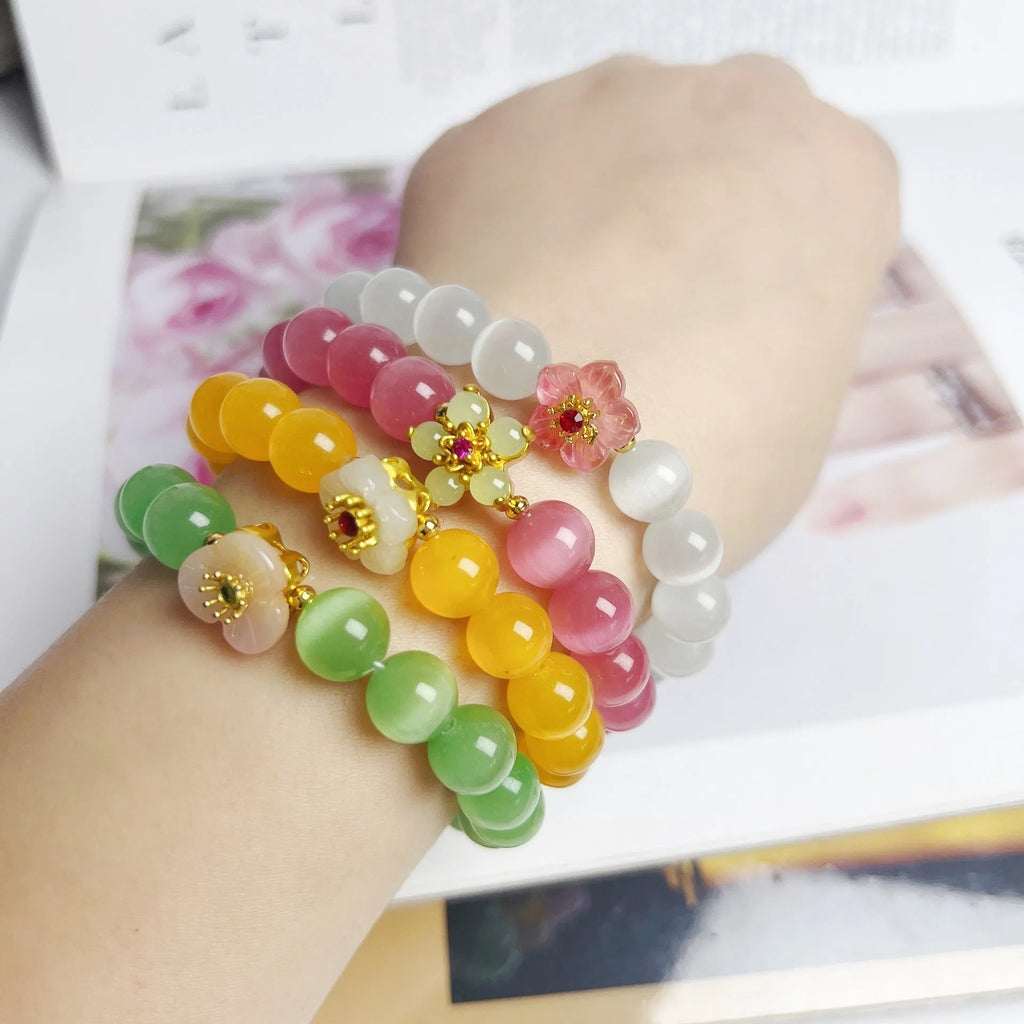 Handmade glass bead bracelet with flower design for women in yellow, pink, white, or green.
