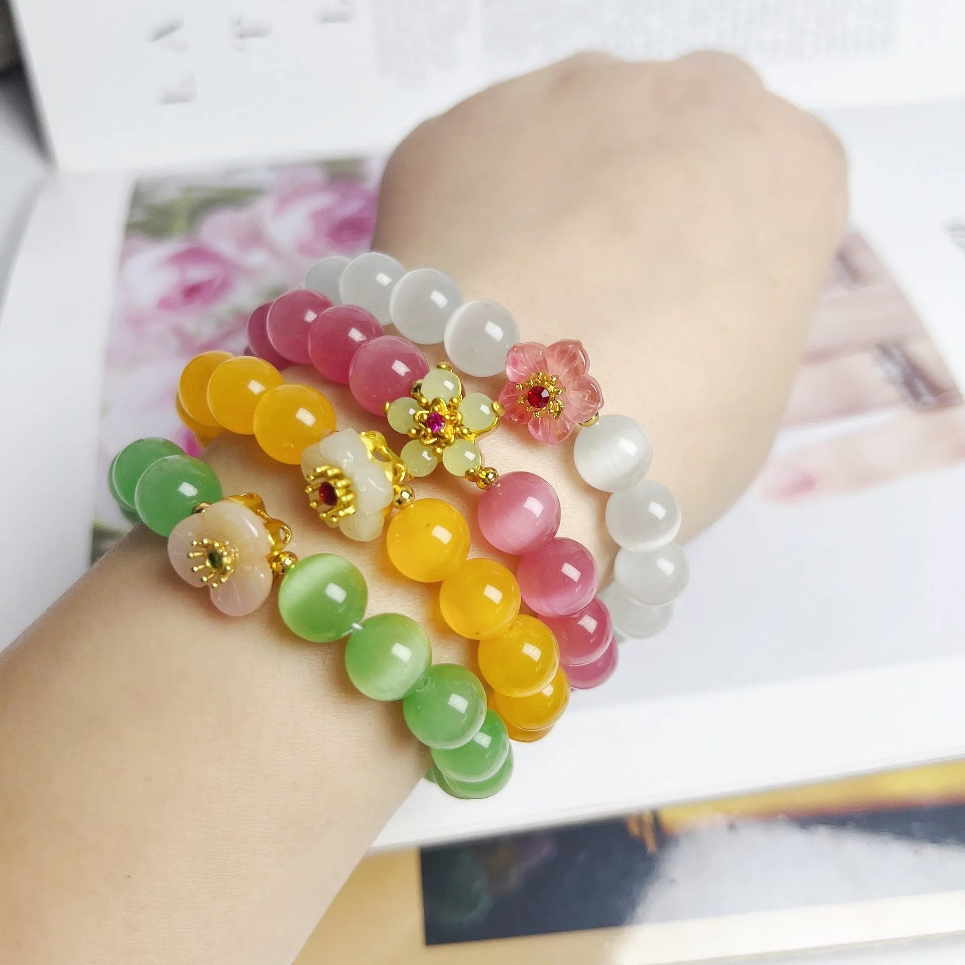Handmade glass bead bracelet with flower design for women in yellow, pink, white, or green.