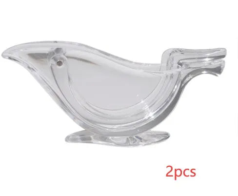 Transparent acrylic manual lemon juicer with bird-shaped design on a kitchen counter