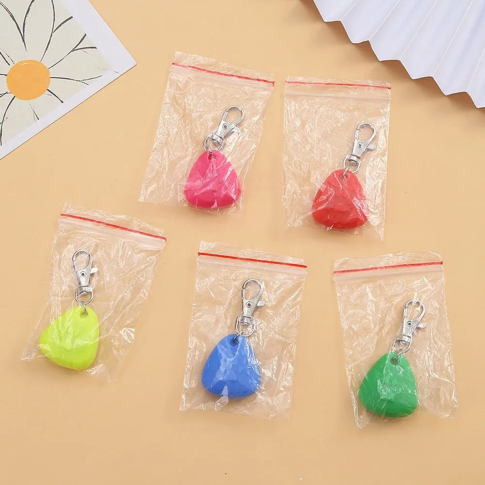 Silicone triangle-shaped pet pendant ornament in assorted colours for light-up collars.
