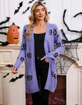 Women's black Halloween cardigan with orange pumpkin head jacquard pattern, shown as a medium-length knitted coat.