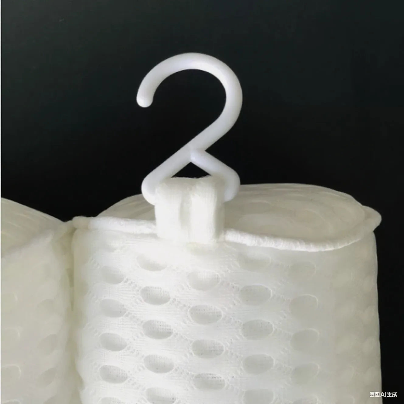 White bathtub pillow with mesh design and suction cups on underside