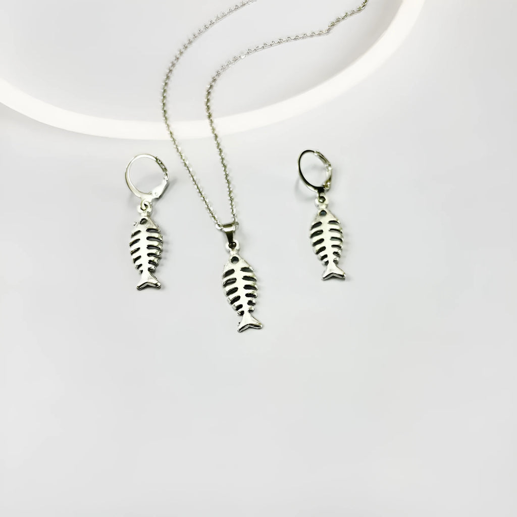Close-up of silver fishbone pendant earrings on a white background, showing O-shaped chain detail.