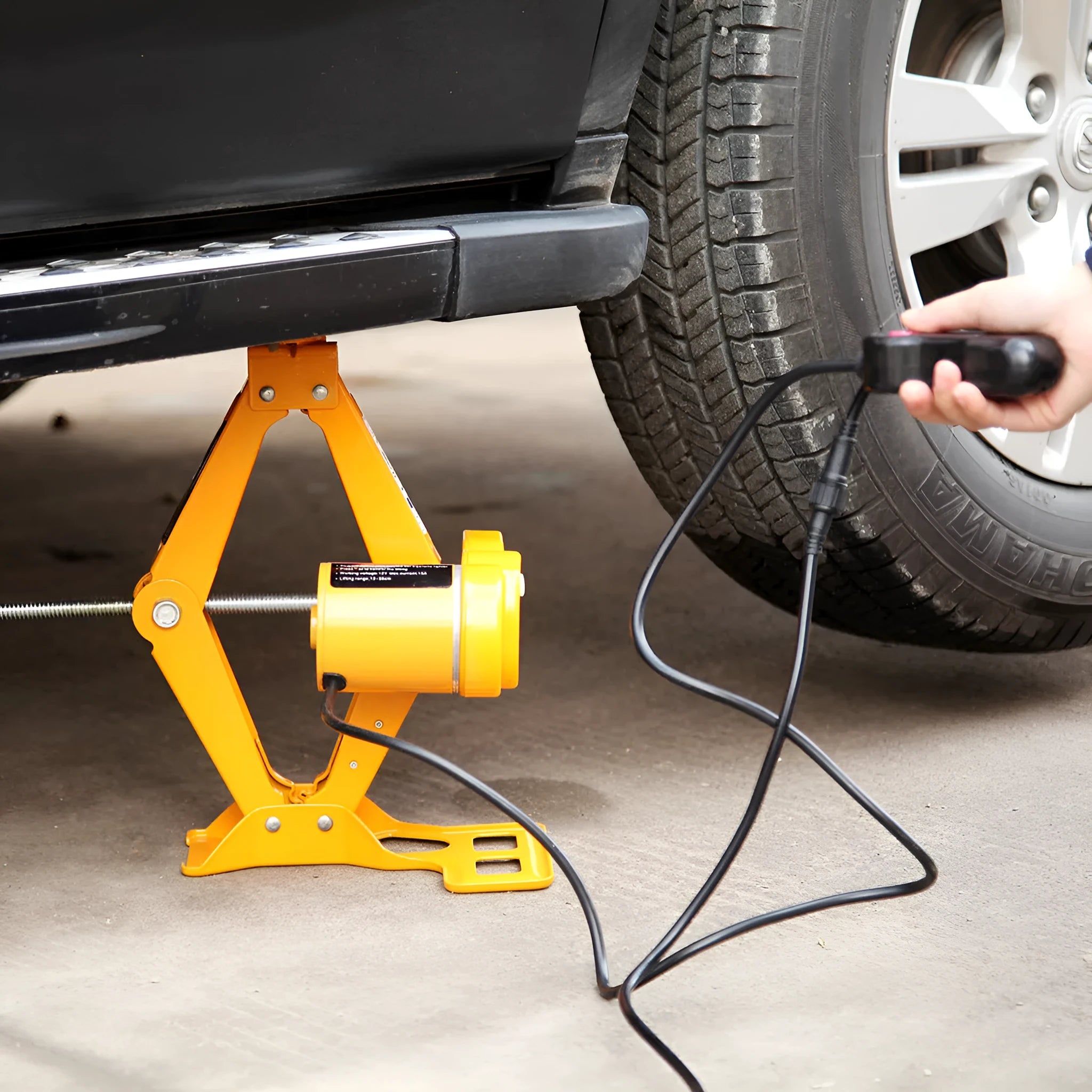 Electric hydraulic car jack with control unit showing 2-ton capacity and height adjustment